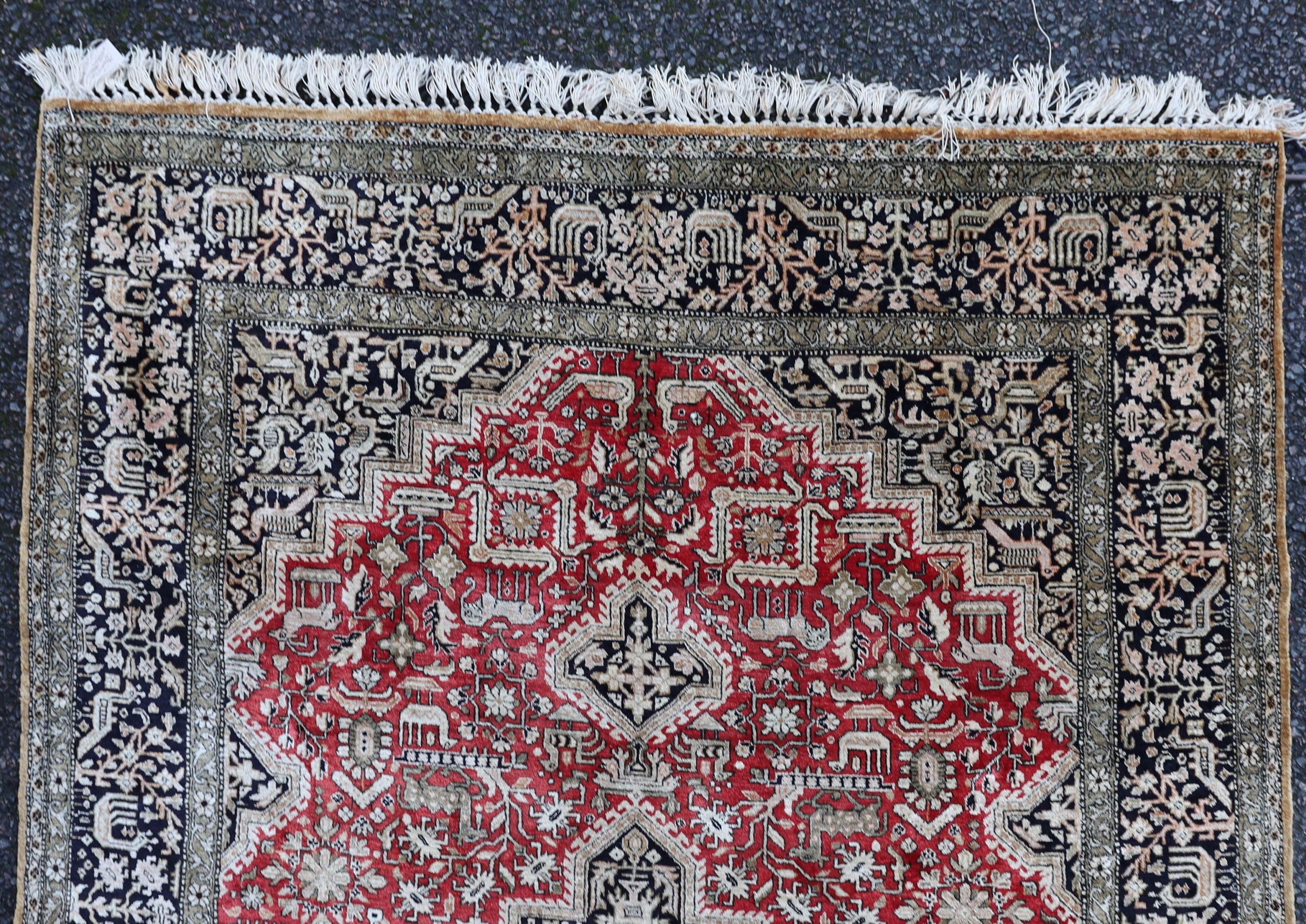 An early 20th century Caucasian silk red ground rug, 206 x 132cm.